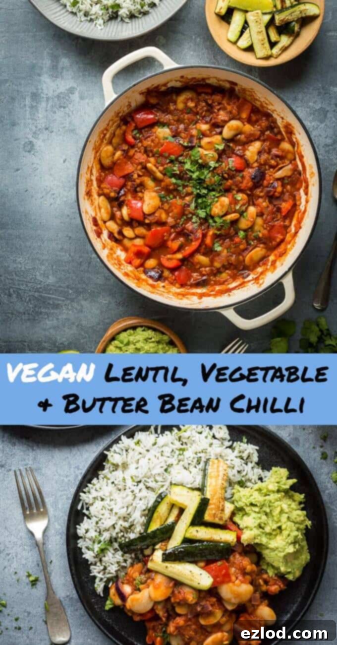 An appetizing close-up of a fully prepared and plated vegan lentil, vegetable, and butter bean chilli meal, highlighting the vibrant colors and textures of the chilli, coriander rice, guacamole, and roasted courgette.