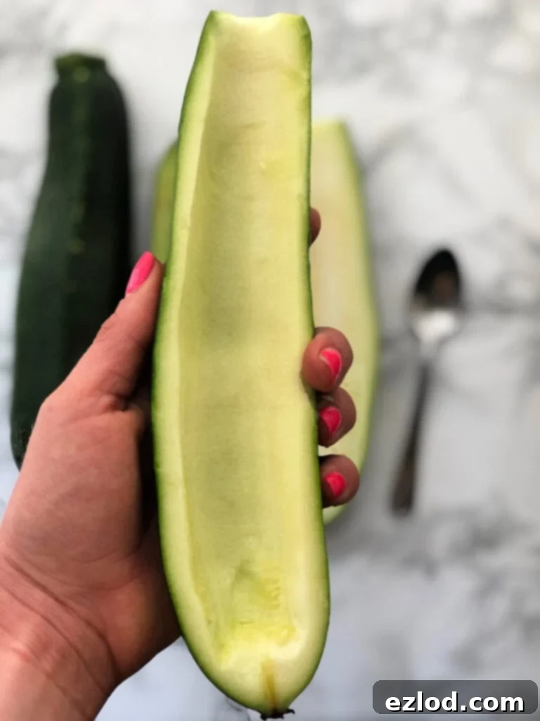 A zucchini with the inside flesh scooped out - being used for zucchini boats