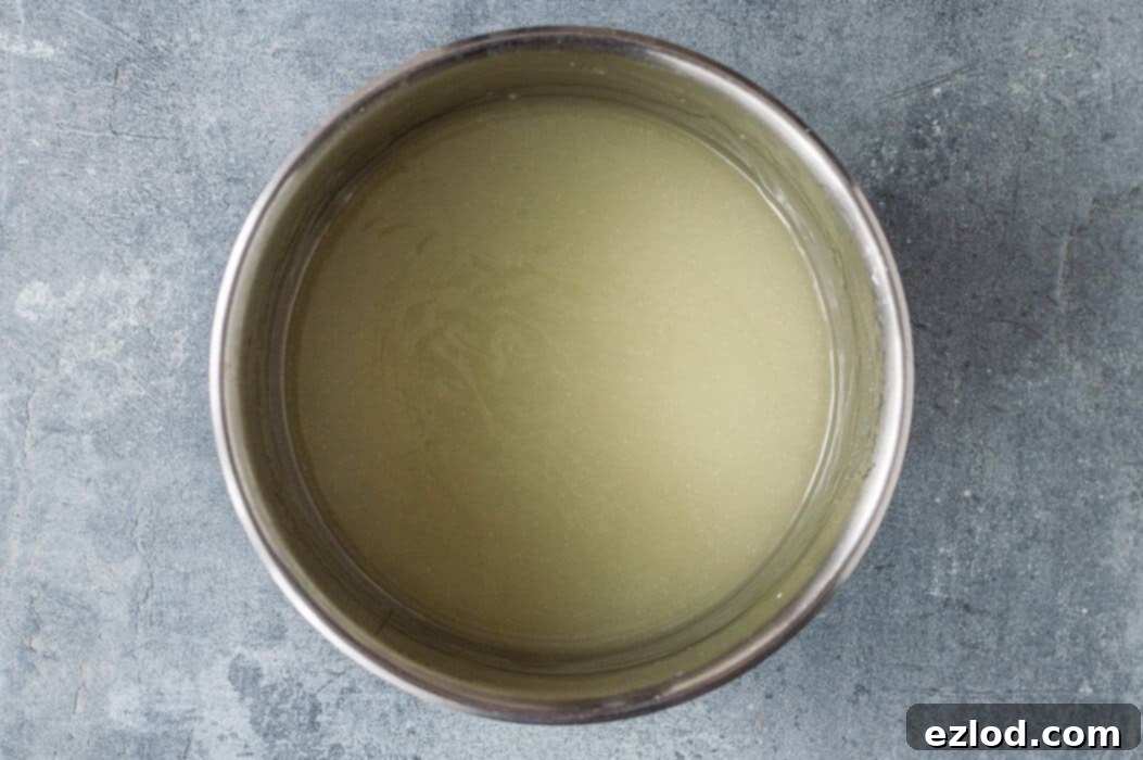 Step two of making vegan coconut lime curd: cooking the mixture in a saucepan over medium-low heat until it thickens.