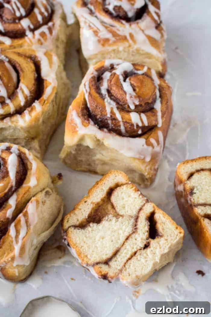 Close up of a vegan banana bread cinnamon roll sliced in half, showing the banana bread dough and cinnamon swirl.