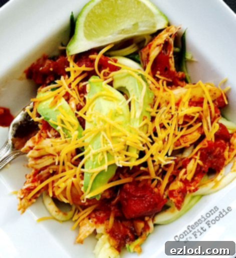 Crock Pot Salsa Lime Chicken served over a bed of spiralized zucchini noodles (zoodles).