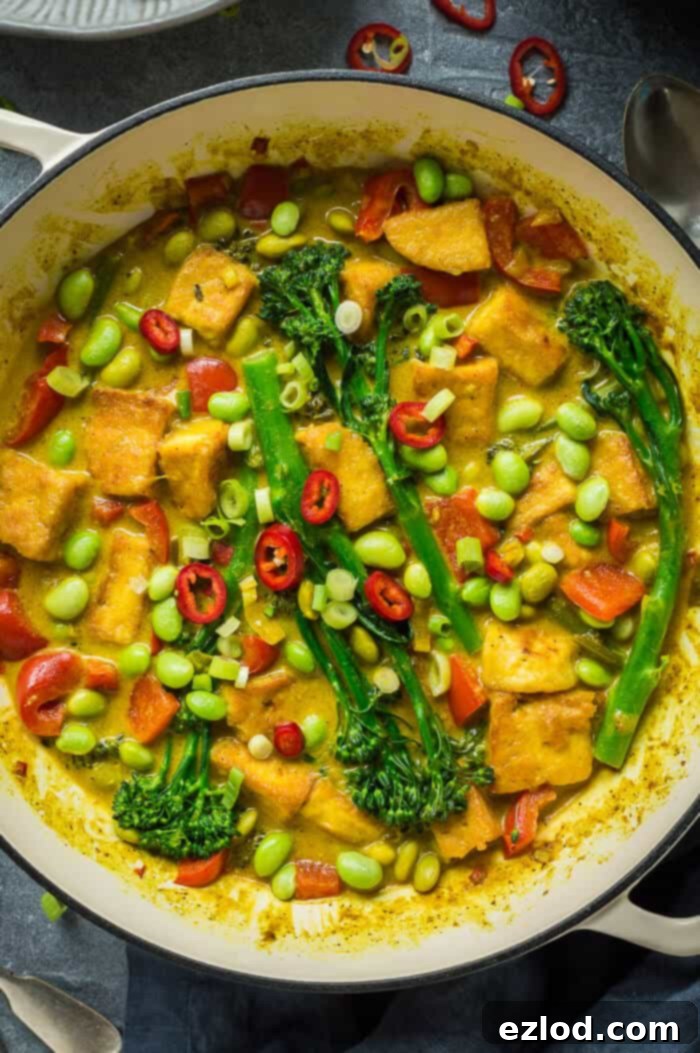 Intimate close-up of a serving of vegan coconut lemongrass curry, highlighting its rich texture and vibrant ingredients.