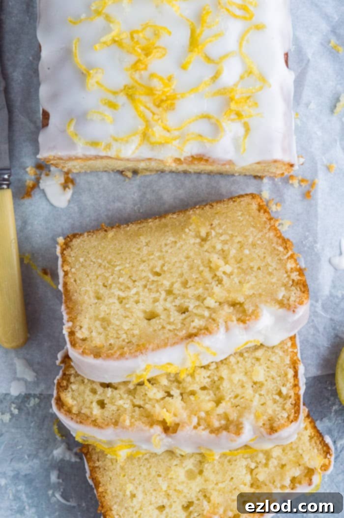 Close up of slices of vegan lemon drizzle cake on a grey background.