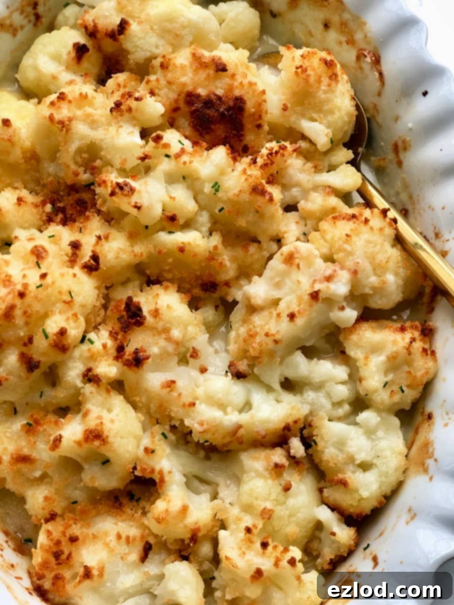Overhead image: crispy roasted cauliflower in cheese sauce