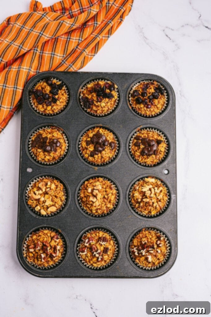 Overhead photo: pumpkin oatmeal muffins in a muffin tin, straight from the oven