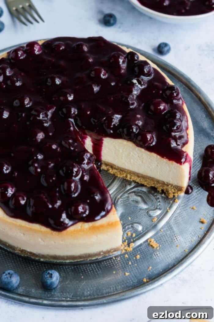 Close-up shot of the creamy texture and vibrant blueberry topping of a delicious vegan lemon blueberry cheesecake.