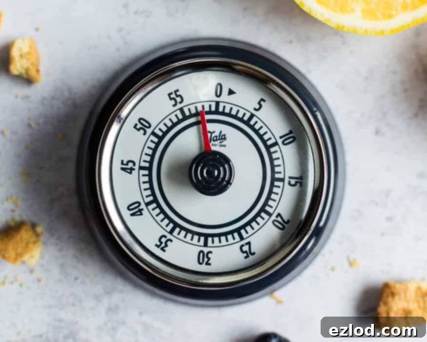 A classic Tala kitchen timer, set and counting down, emphasizing the importance of precise timing in baking.