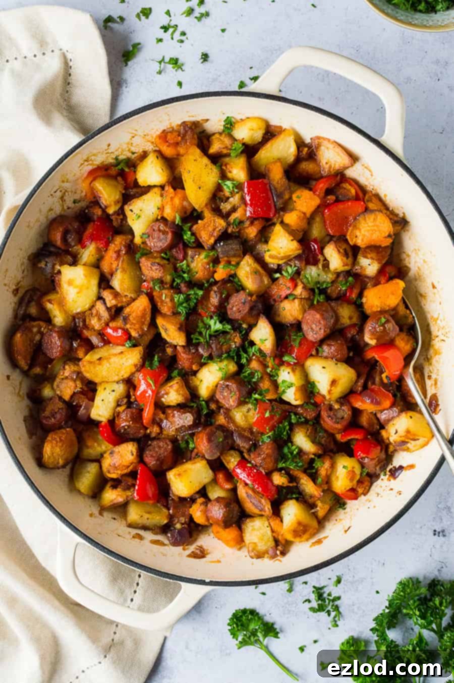 Close up of a delicious and hearty panful of vegan chorizo and potato hash, perfect for any meal. A vibrant close-up of a pan of vegan chorizo potato hash, showing crispy potato pieces, chunks of vegan chorizo, and finely chopped bell peppers.