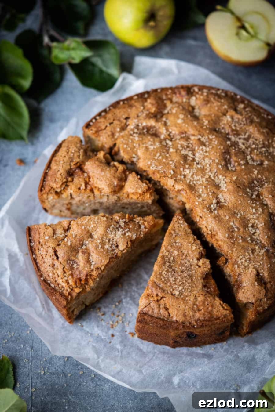 A beautiful side view of a perfectly baked vegan apple cake, showcasing its golden crust and inviting texture.