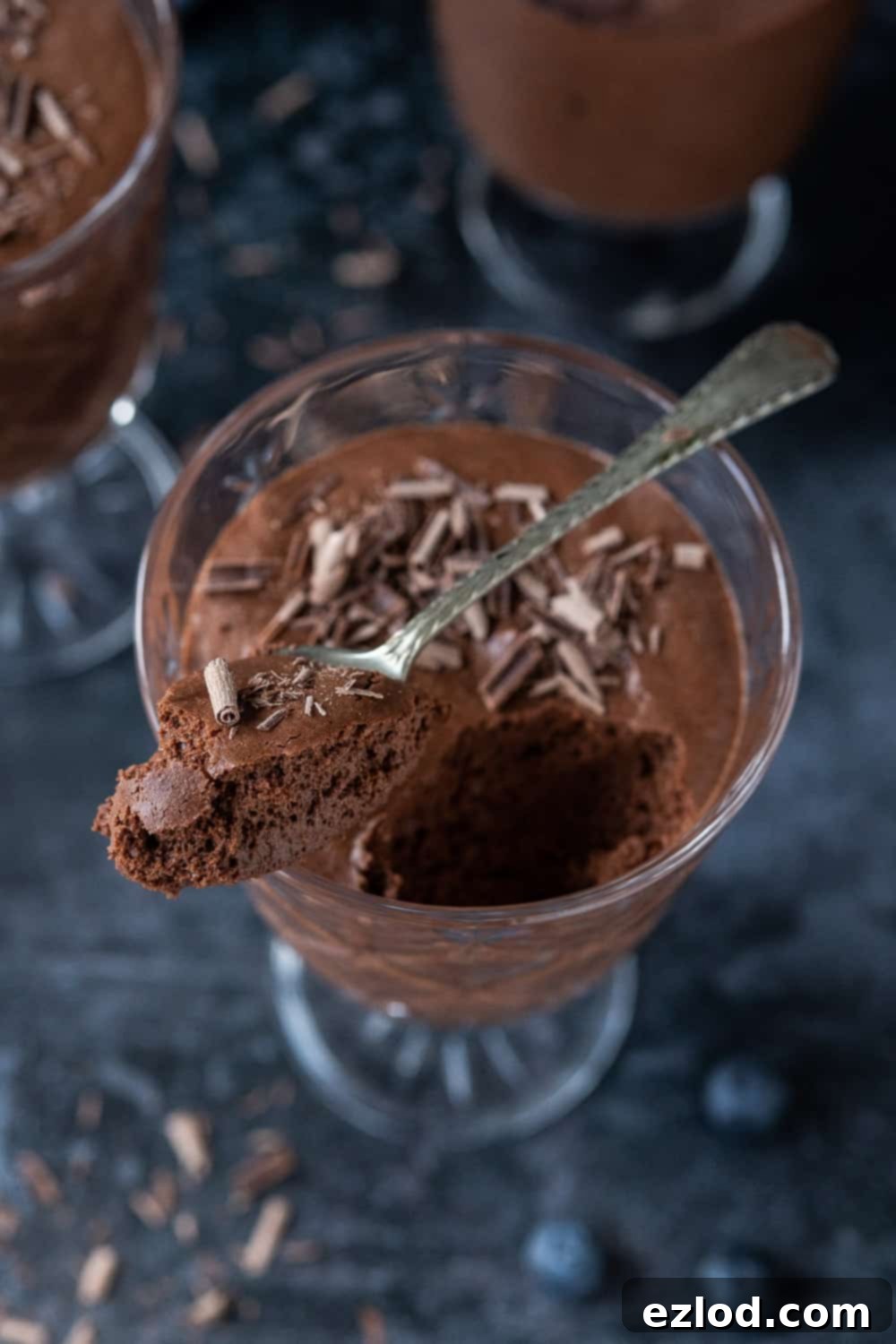Spoonful of Vegan Chocolate Mousse Close up of a spoonful of vegan chocolate mousse resting on the rim of a glass.