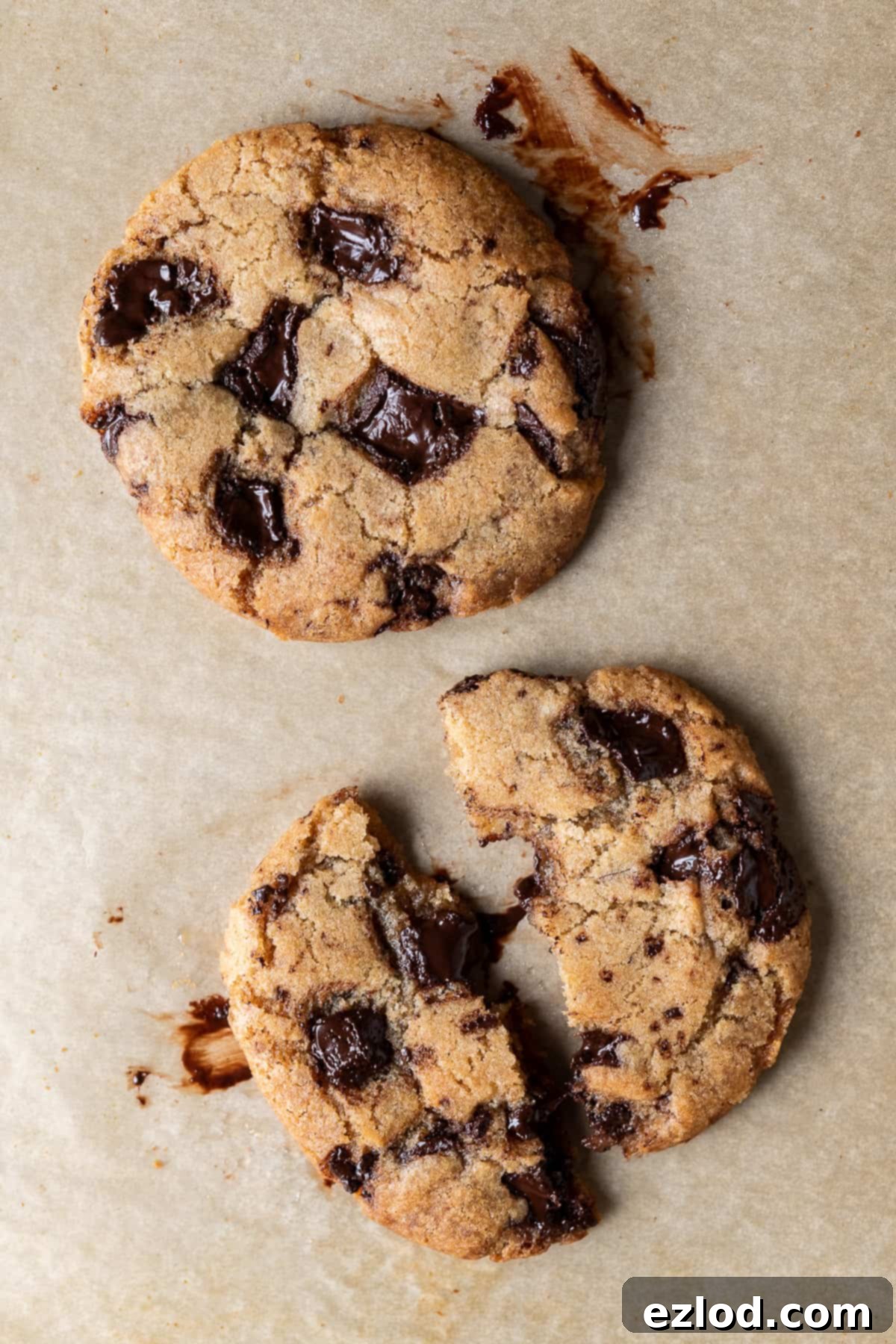 Two Small Batch Vegan Chocolate Chip Cookies Two perfect small batch vegan chocolate chip cookies for one, resting on a sheet of brown baking parchment, ready to be enjoyed.