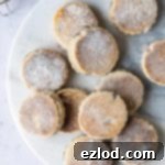 Heavenly Vegan Welsh Cakes 6 A stack of golden-brown vegan Welsh cakes, lightly dusted with sugar.