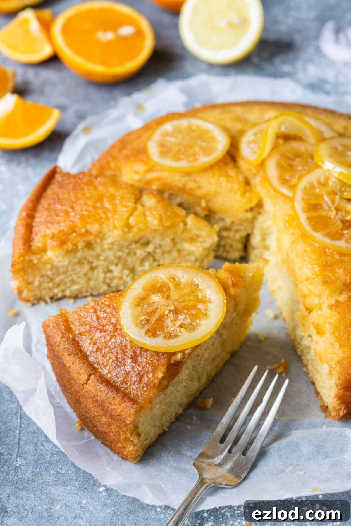 Single Slice of Vegan Semolina Cake with Candied Lemon Close-up of a slice of vegan semolina cake, beautifully garnished with a candied lemon slice, showcasing its moist texture