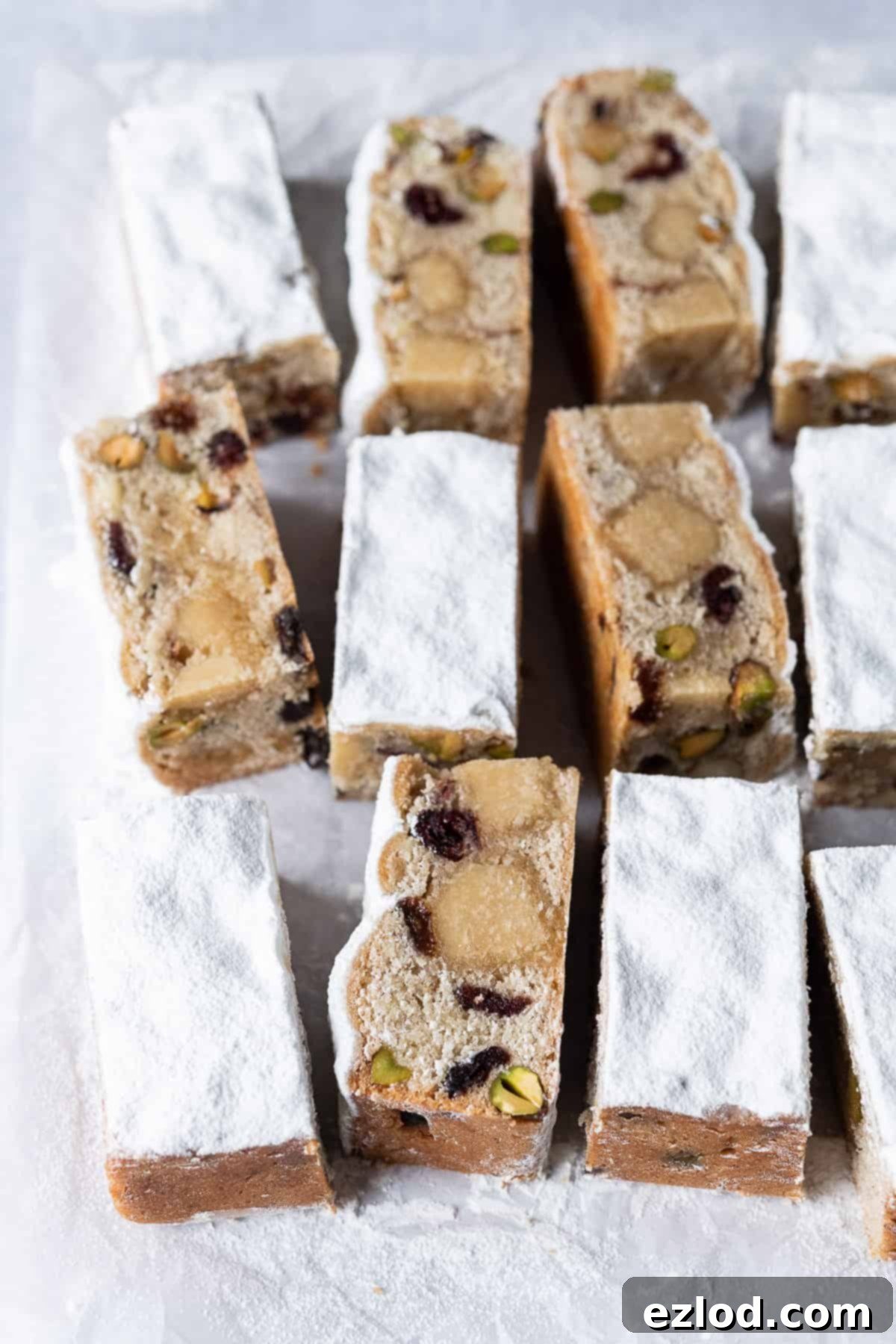 No-Yeast Vegan Stollen Bars: A Festive German Treat for the Holidays. Vegan stollen bars on a sheet of white baking parchment, ready for serving.