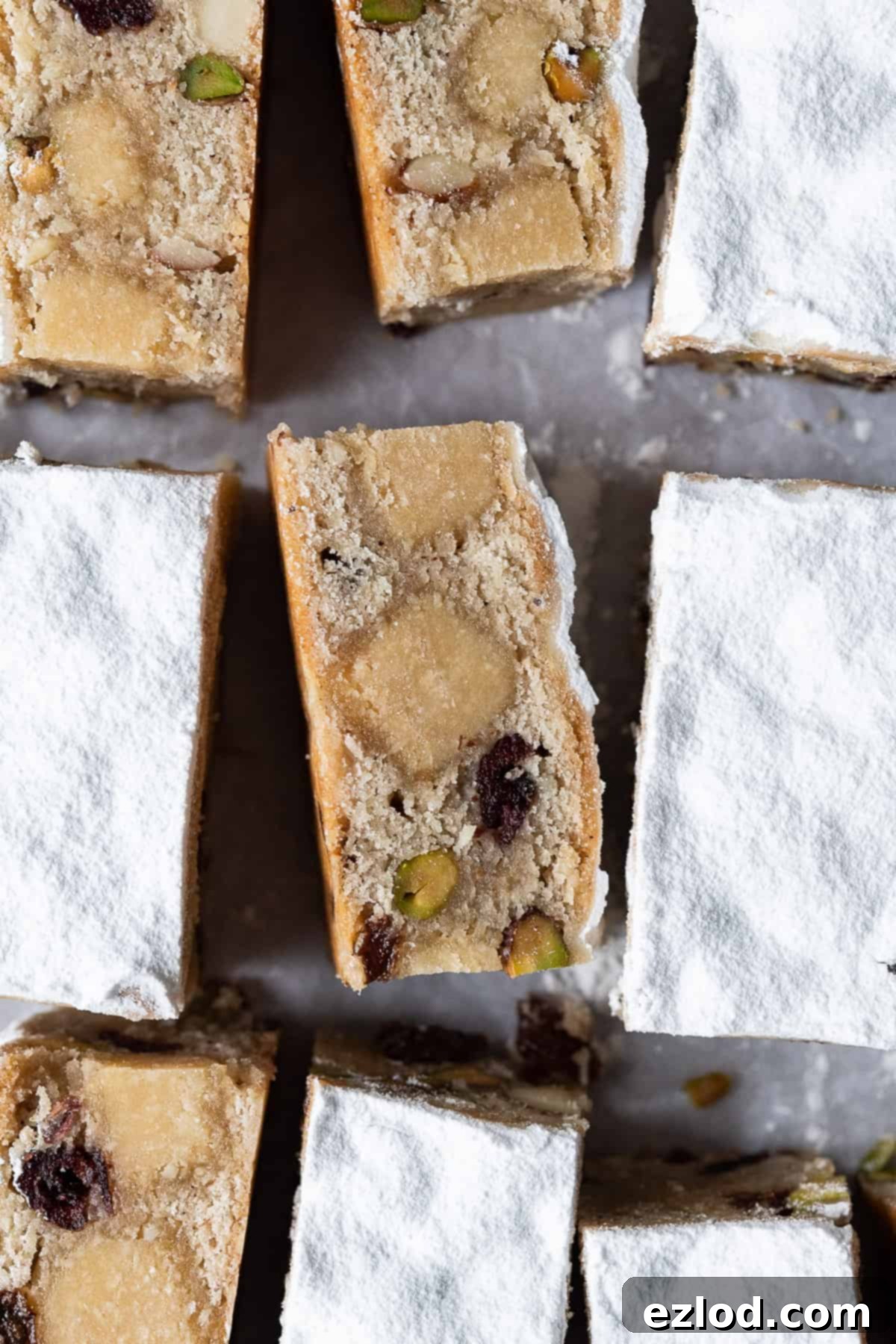Rich and Moist Vegan Stollen Bar with Marzipan and Spices. Close up of a moist vegan stollen bar, showing its dense texture and fruit inclusions.