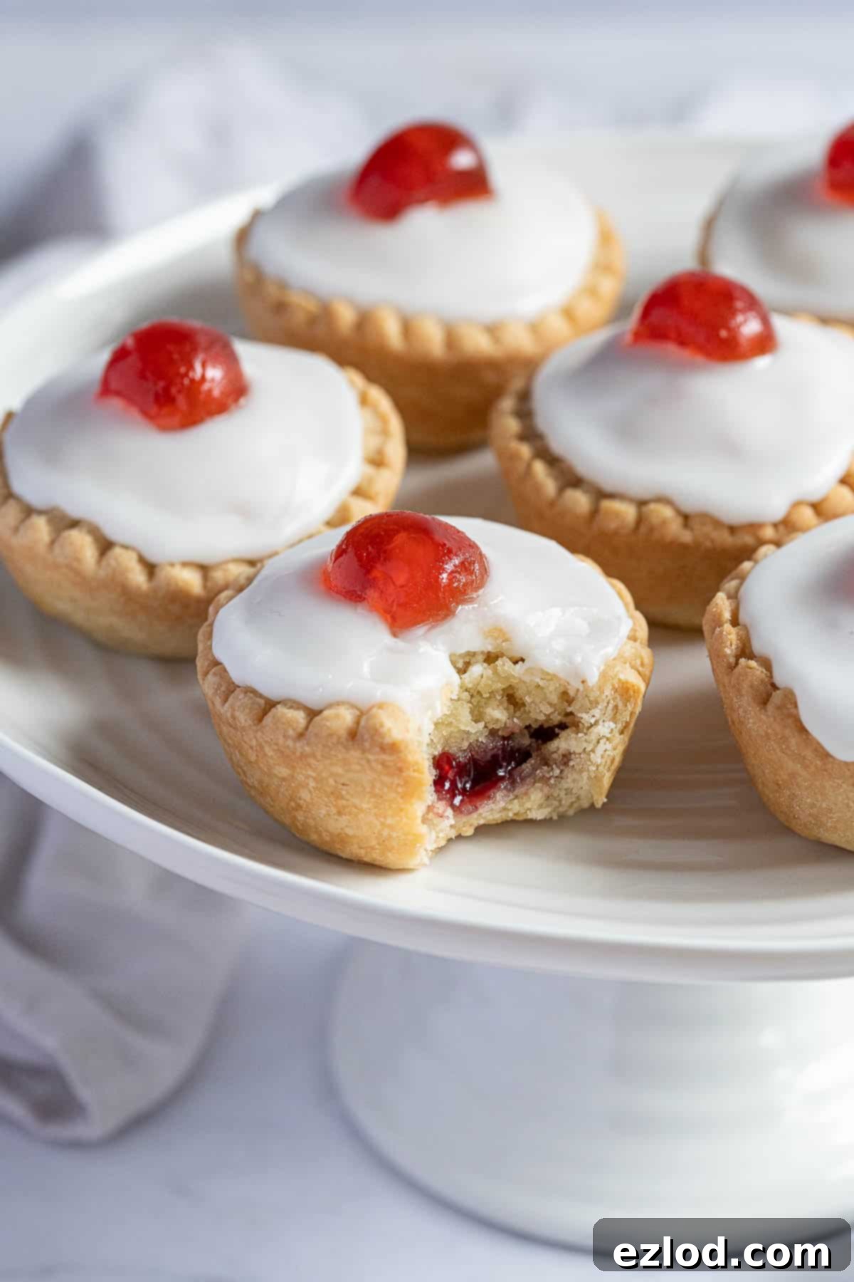 Irresistible Vegan Cherry Bakewells 3 Close up of a vegan cherry Bakewell with a bite taken out of it.