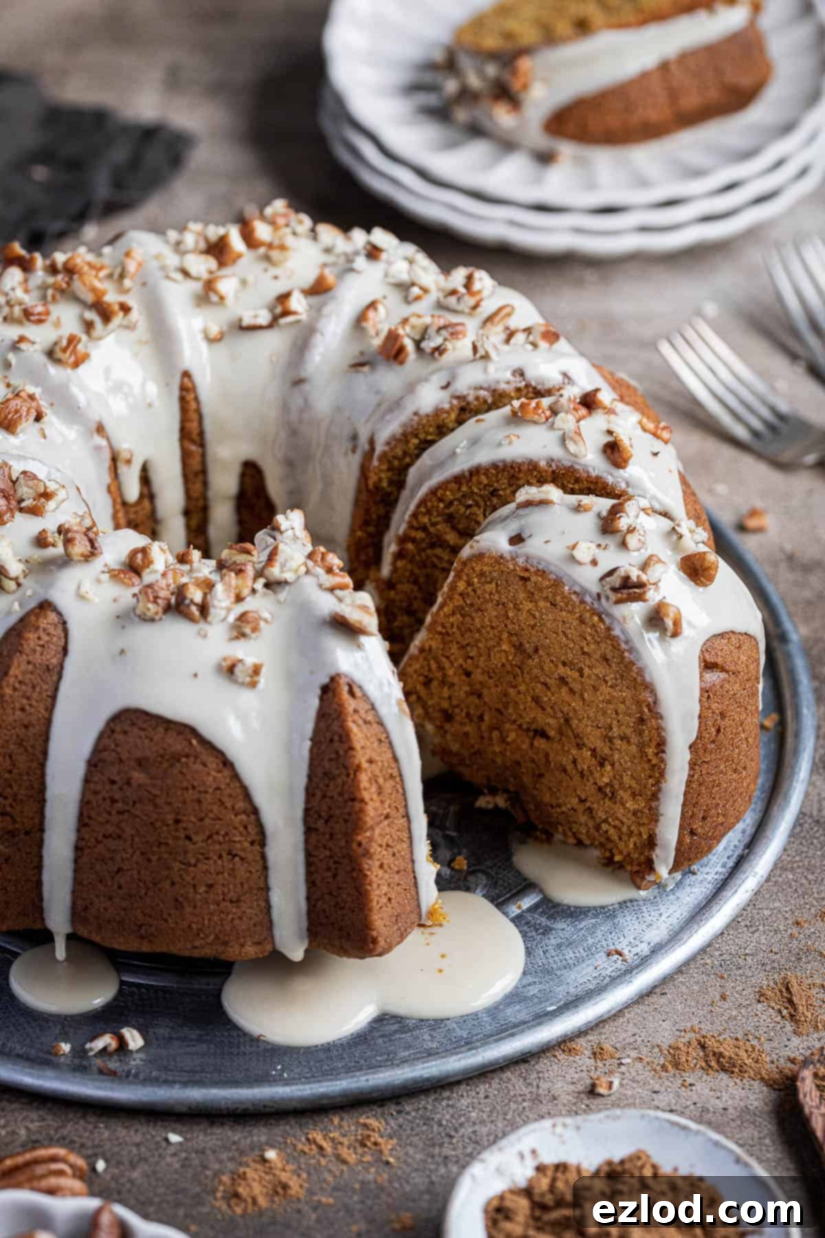 Cozy Vegan Pumpkin Bundt Delight 6 A close-up shot of the beautifully sliced vegan pumpkin bundt cake, revealing its moist and tender crumb, topped with a delicate maple glaze.
