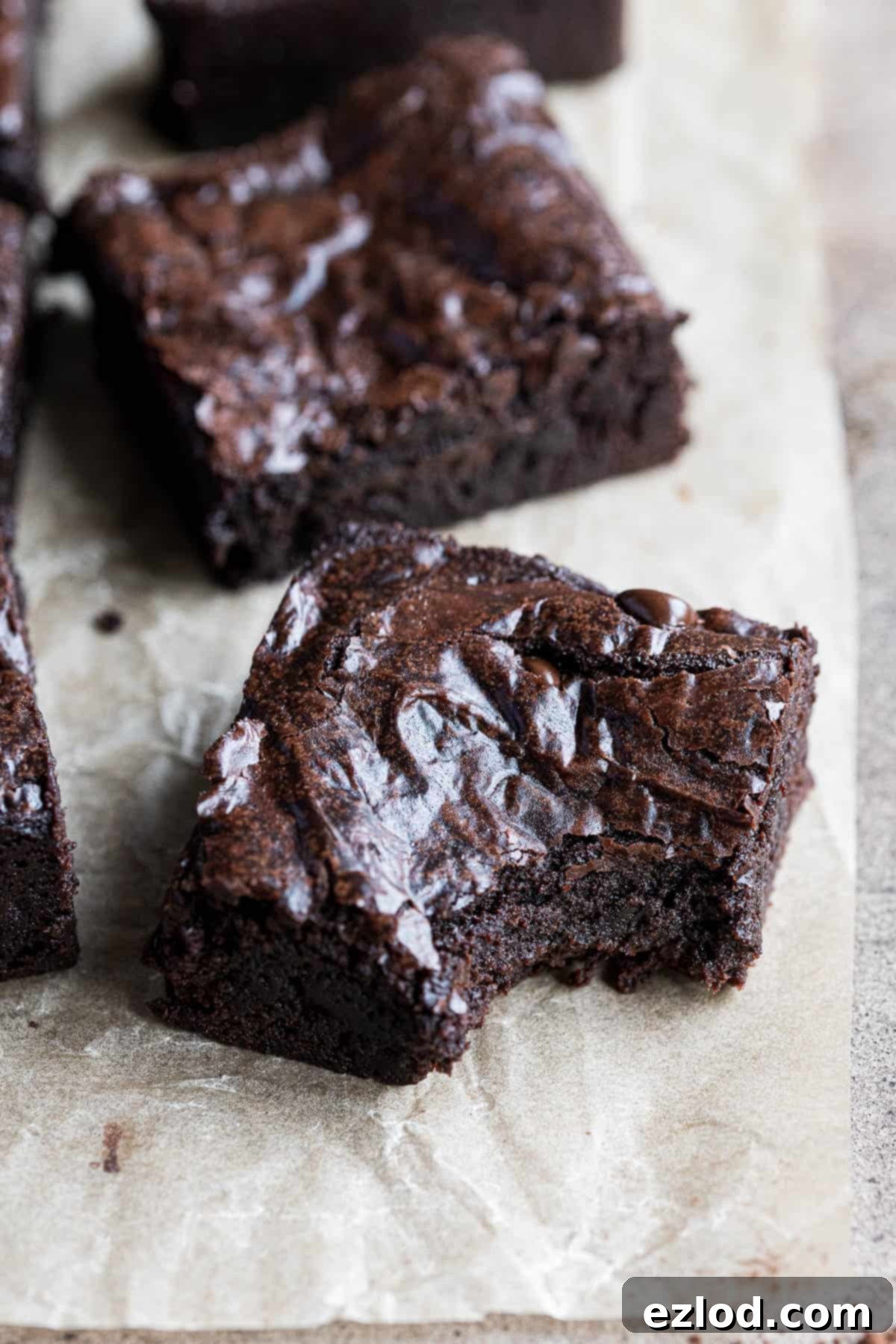 Seriously Fudgy Plant-Powered Brownies 4 Close up of a fudgy vegan brownie with a bite taken out of it, showing the dense texture.