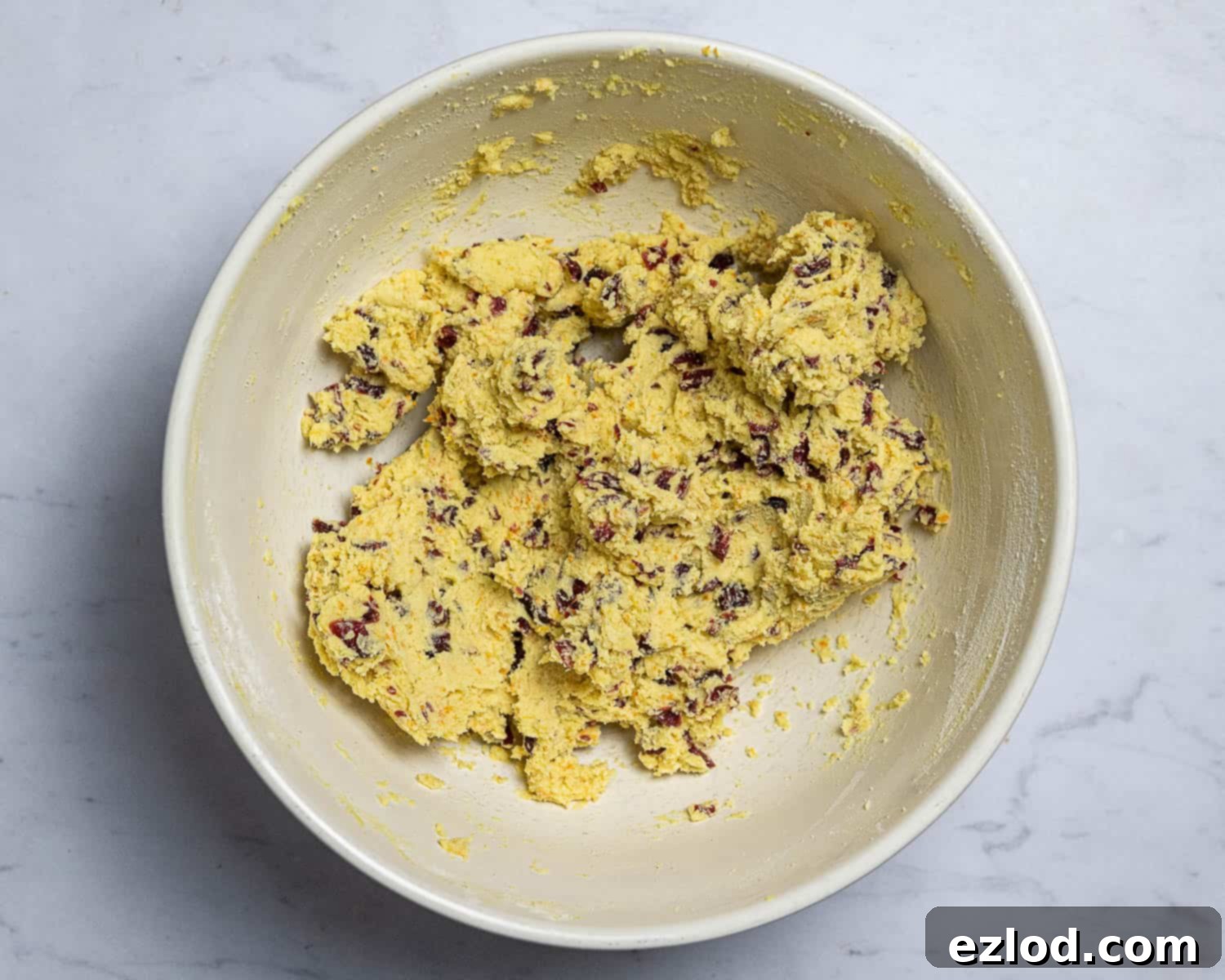 Vegan Zesty Cranberry Orange Shortbread 6 Step 3: Folding in the finely chopped dried cranberries into the vegan shortbread dough.