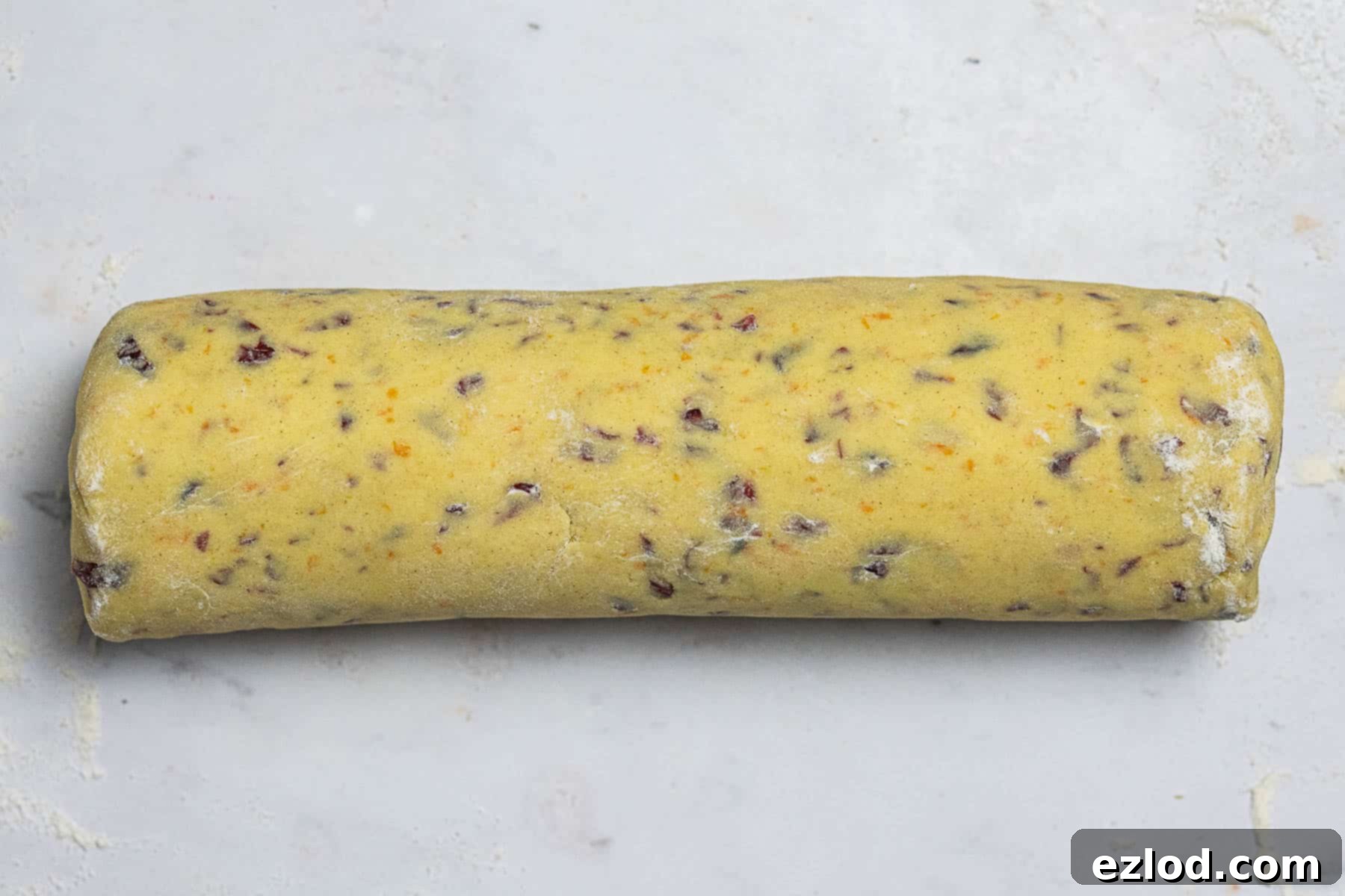 Vegan Zesty Cranberry Orange Shortbread 7 Step 4: The vegan cranberry orange shortbread dough shaped into a uniform log, ready for chilling.