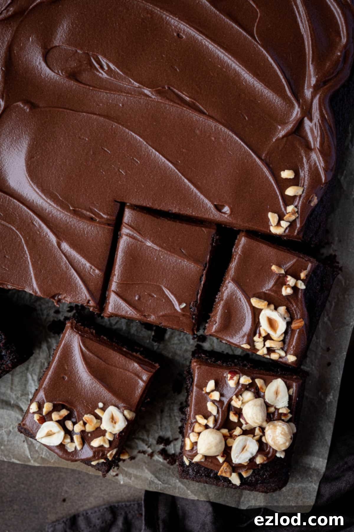 Decadent Vegan Chocolate Hazelnut Cake 13 A close-up view of multiple slices of vegan chocolate hazelnut cake, showcasing the rich chocolate crumb and a thick, smooth layer of hazelnut ganache on top, making for a tempting display.