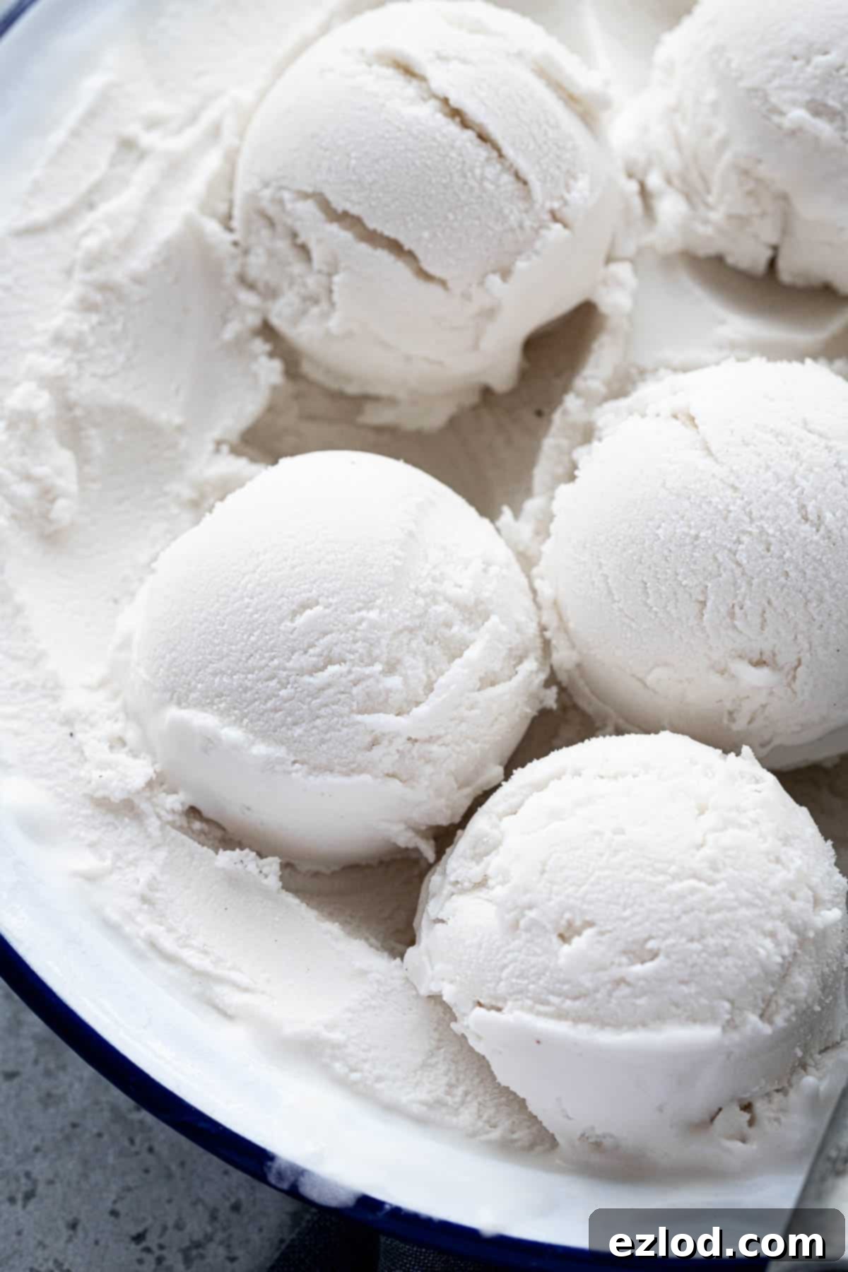 Effortless Vegan Coconut Ice Cream 3 Close up of perfectly scooped easy vegan coconut ice cream in a bowl, highlighting its creamy consistency.