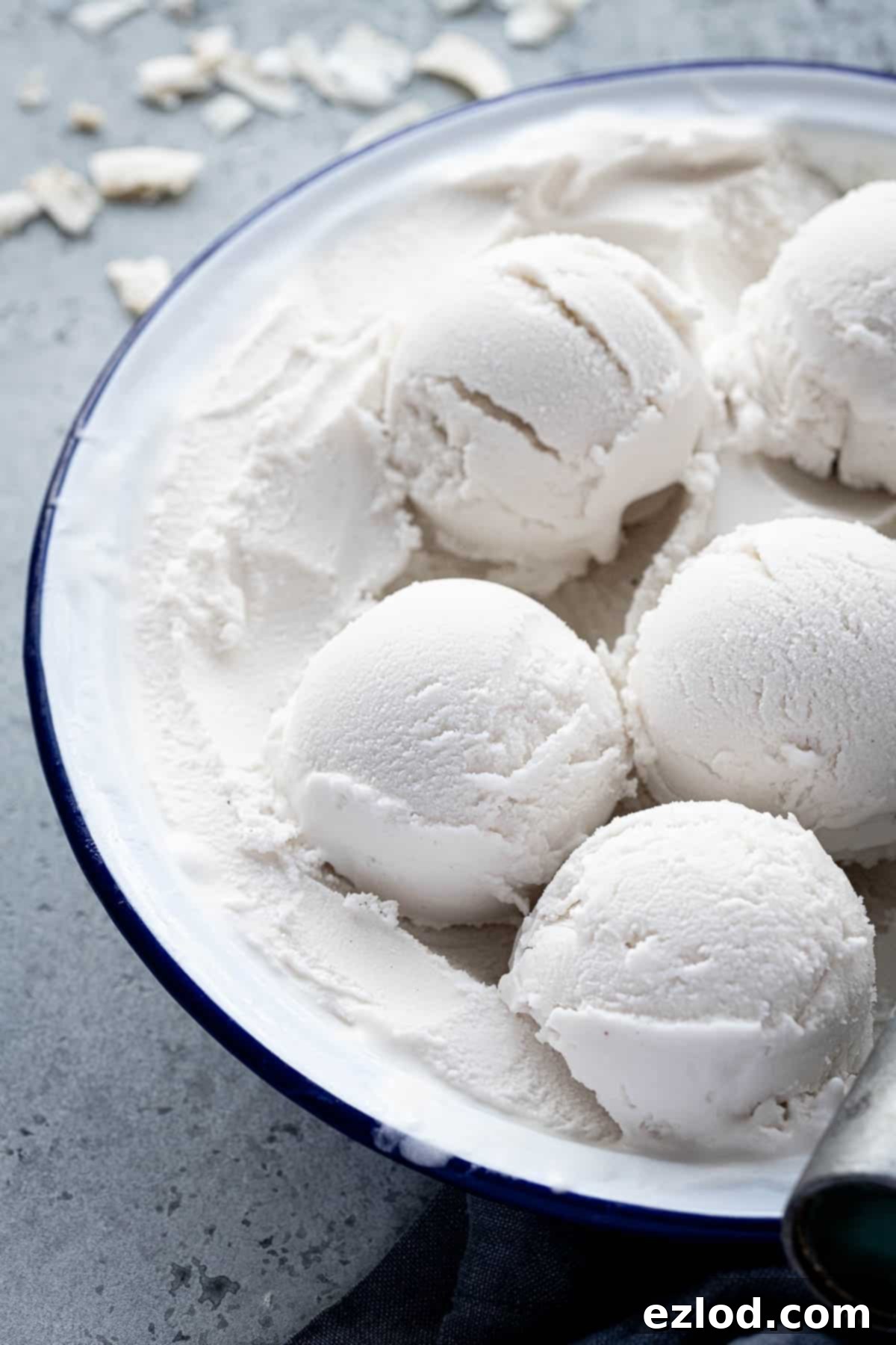 Effortless Vegan Coconut Ice Cream 7 Scoops of easy vegan coconut ice cream elegantly arranged in a round serving dish, ready for sharing.