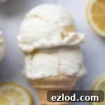 Refreshing Vegan Lemon Delight 11 Close up of two scoops of ice cream in a cone.