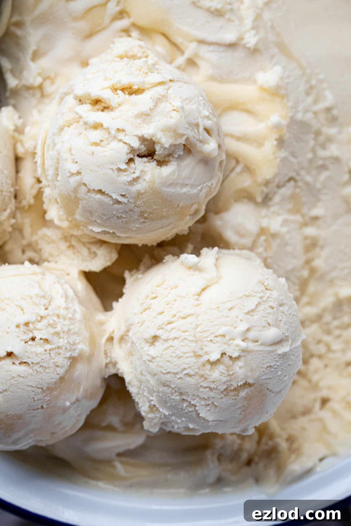 Refreshing Vegan Lemon Delight 3 A close-up view of several scoops of golden vegan lemon ice cream, showcasing its smooth and inviting texture.