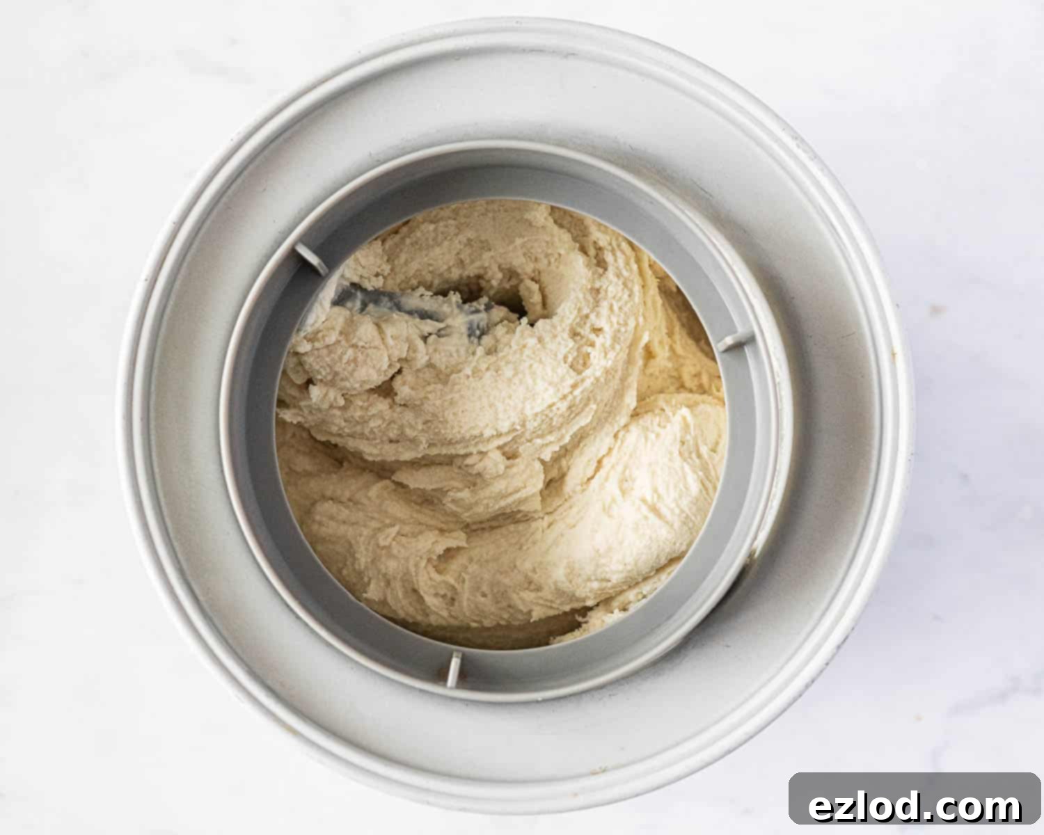 Refreshing Vegan Lemon Delight 8 Step 4: The vegan lemon ice cream actively churning in an ice cream maker, beginning to achieve its desired soft-serve consistency.