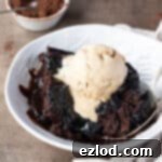 Decadent Vegan Chocolate Lava Pudding 11 A slice of self-saucing chocolate pudding in a bowl with a scoop of ice cream.