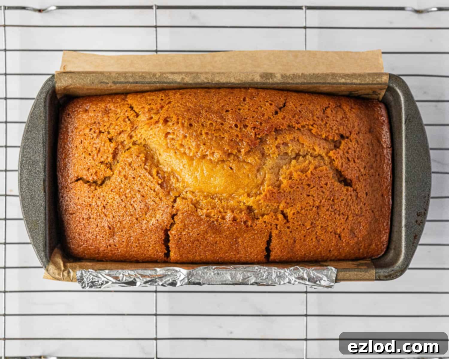 Vegan Liquid Gold Cake 8 Step-by-step image of the beautifully baked vegan golden syrup cake, still in its loaf tin, showcasing its golden-brown crust.
