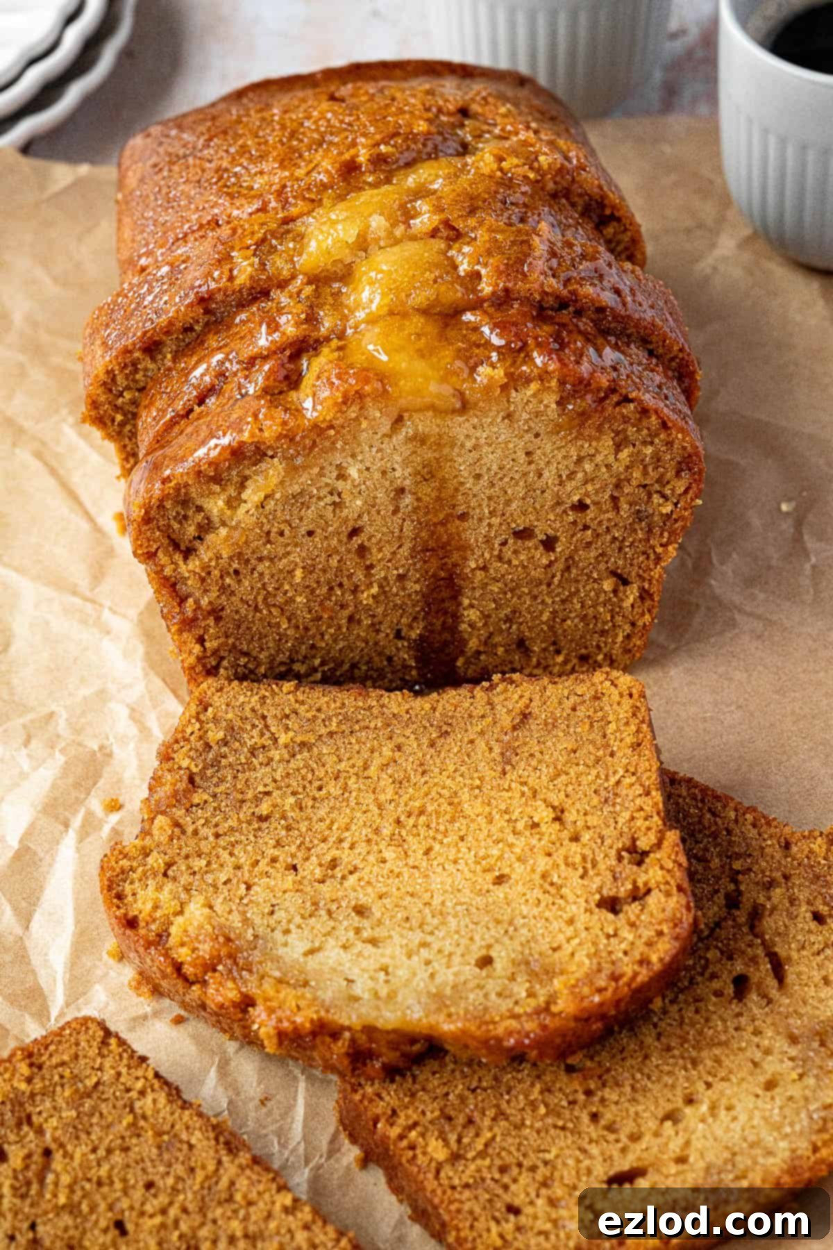 Vegan Liquid Gold Cake 10 A close-up view of a perfectly sliced vegan golden syrup cake, showing its moist, tender crumb and sticky golden top.