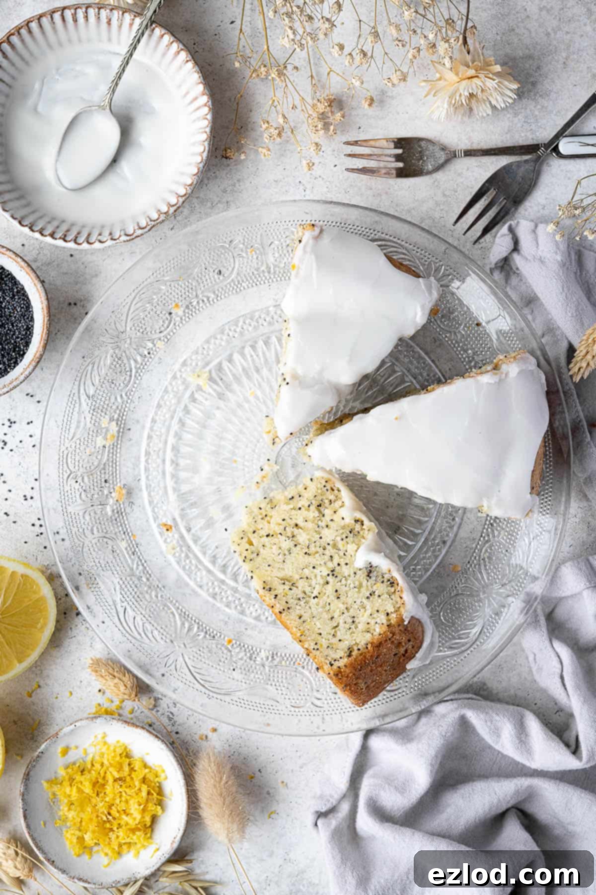 Zesty Vegan Lemon Poppy Seed Cake 10 Three perfectly cut slices of vegan lemon poppy seed cake, showcasing its light and moist crumb, arranged neatly on a glass plate.