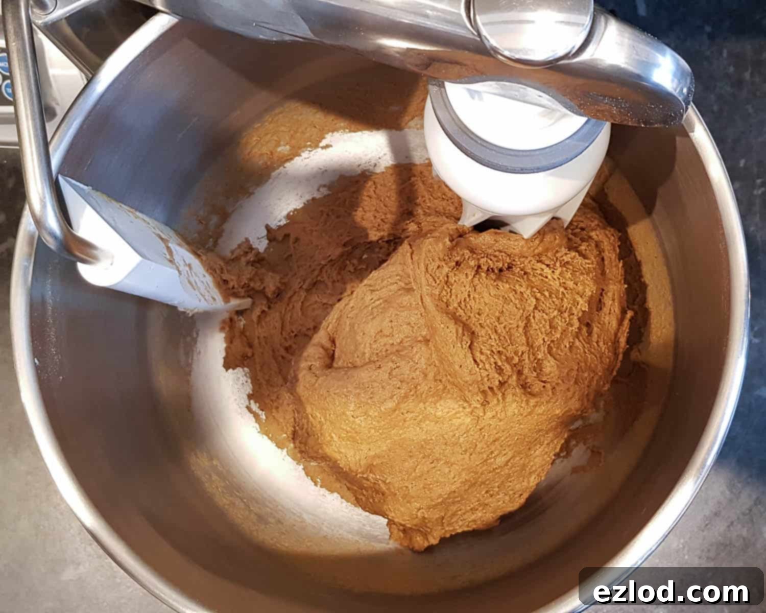 Jamaican Plant-Based Spiced Bun 6 Step 2: The dough has just started to come together in the stand mixer, looking rough and sticky.