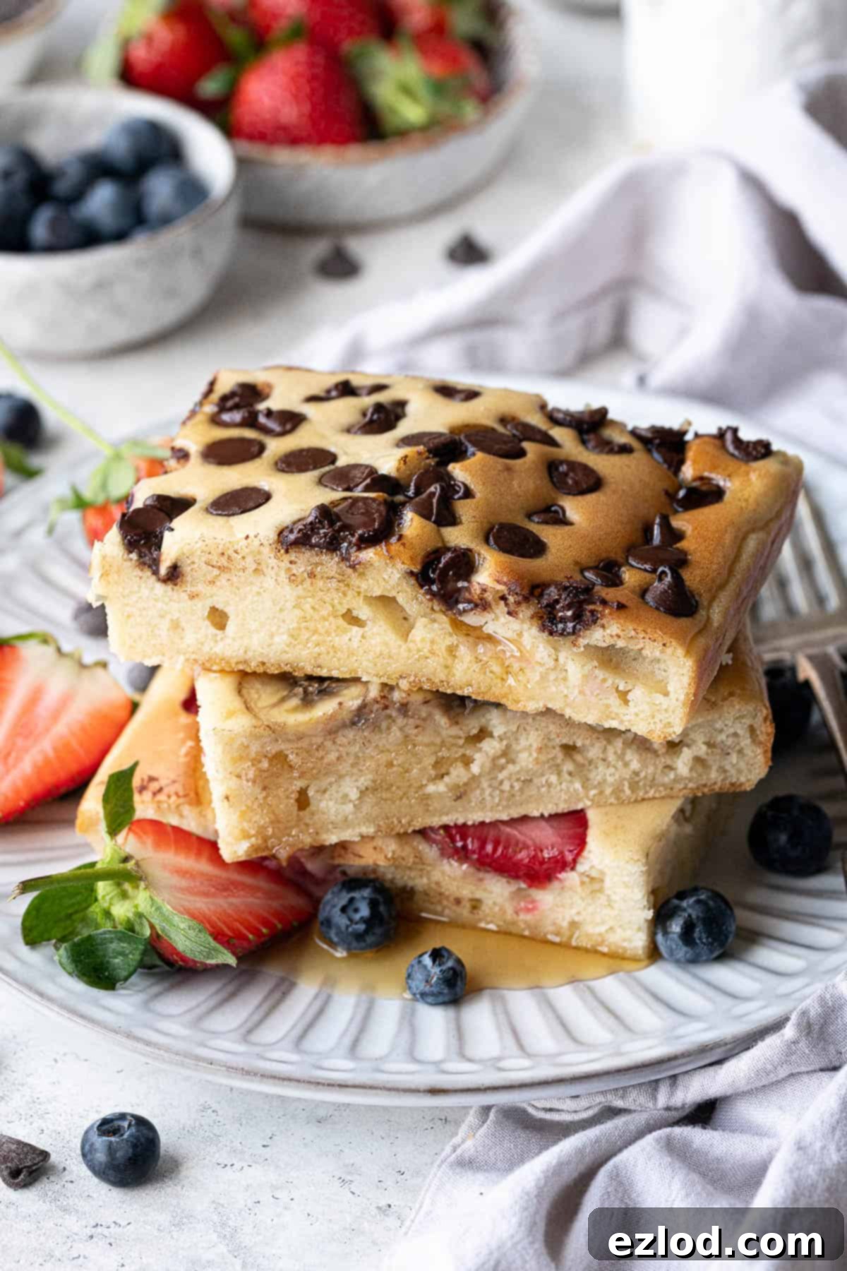 Effortless Vegan Sheet Pan Pancakes 3 A stack of vegan cheet pan pancakes on a white plate.