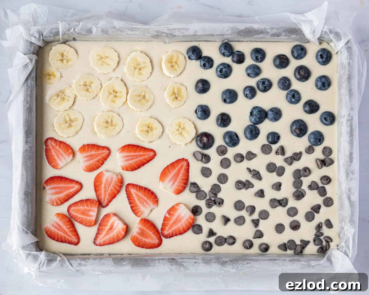 Effortless Vegan Sheet Pan Pancakes 7 Step 3, the batter with toppings before baking.