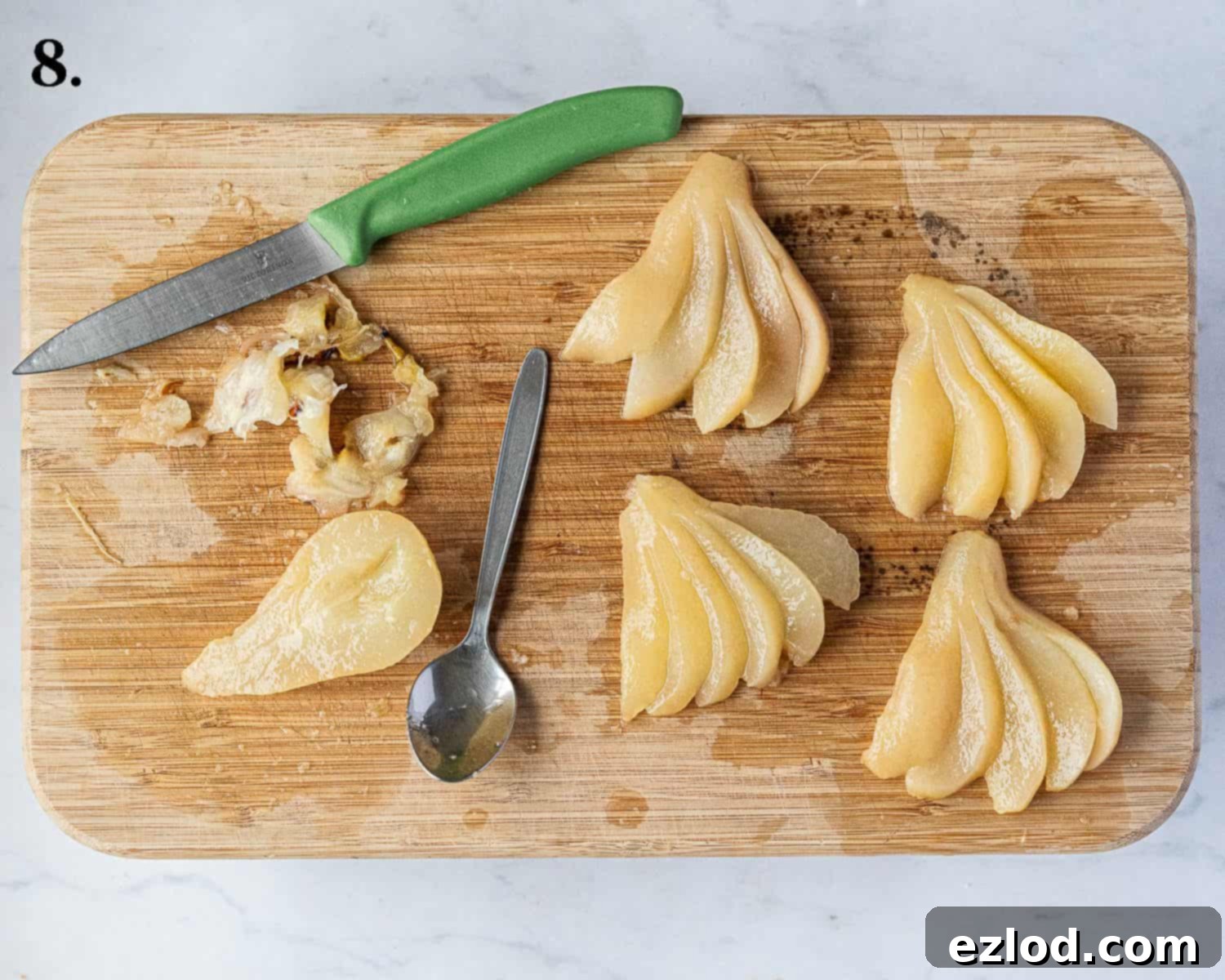 Rich Vegan Chocolate Pear Almond Tart 12 Step-by-step image illustrating how to slice and fan out poached pear halves for an elegant tart topping.