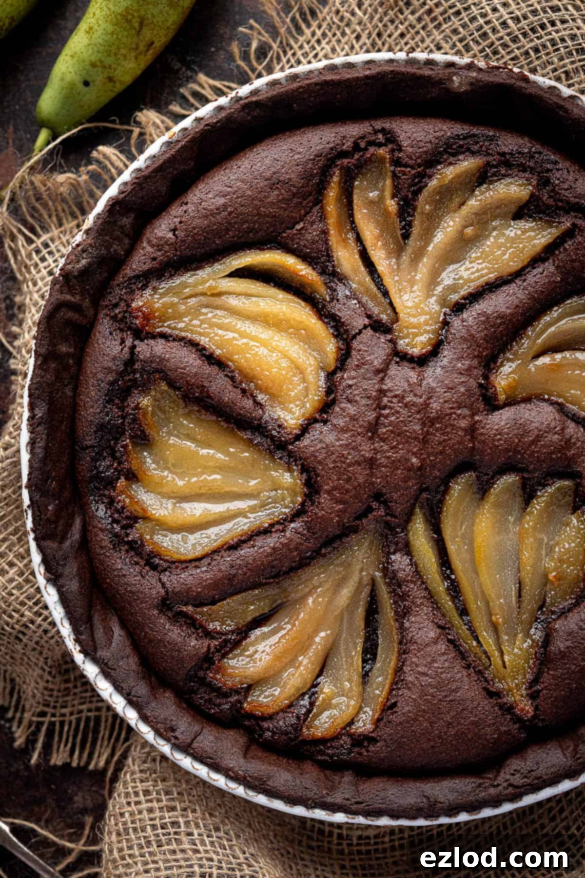 Rich Vegan Chocolate Pear Almond Tart 15 A high-angle close-up shot of the finished vegan chocolate pear frangipane tart, showcasing its beautiful textures and presentation.