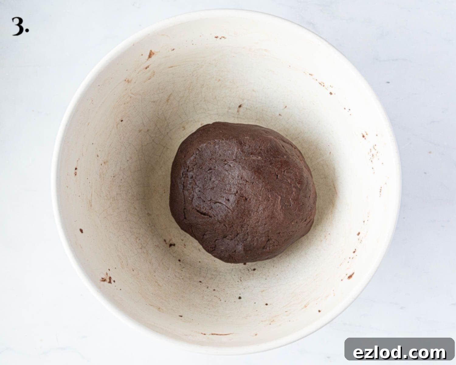 Rich Vegan Chocolate Pear Almond Tart 7 Step-by-step image showing the prepared vegan chocolate pastry dough shaped into a disc, ready for chilling.