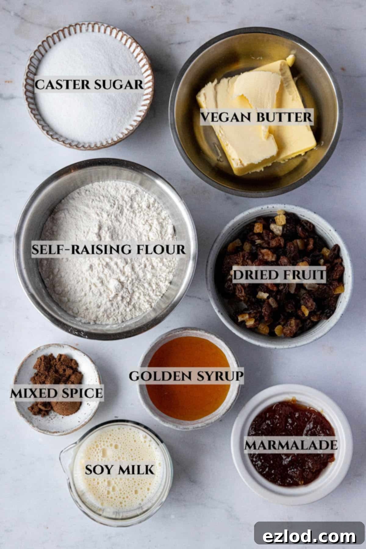 Zesty Vegan Marmalade Tea Loaf 3 A beautifully arranged selection of ingredients required for baking the vegan marmalade tea loaf, clearly labelled for ease of identification.