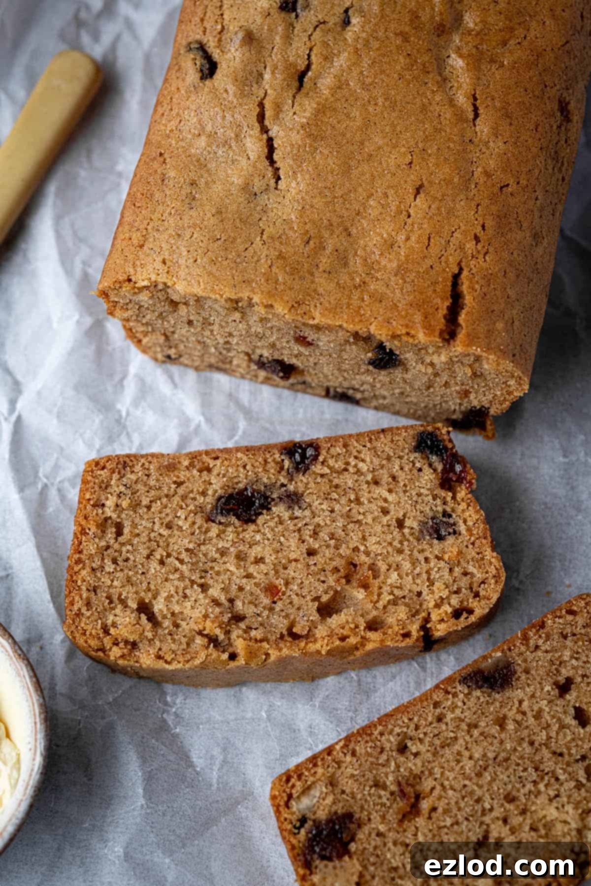 Zesty Vegan Marmalade Tea Loaf 4 A close-up view of a beautifully sliced vegan marmalade tea loaf, showcasing its moist crumb and rich fruit distribution.