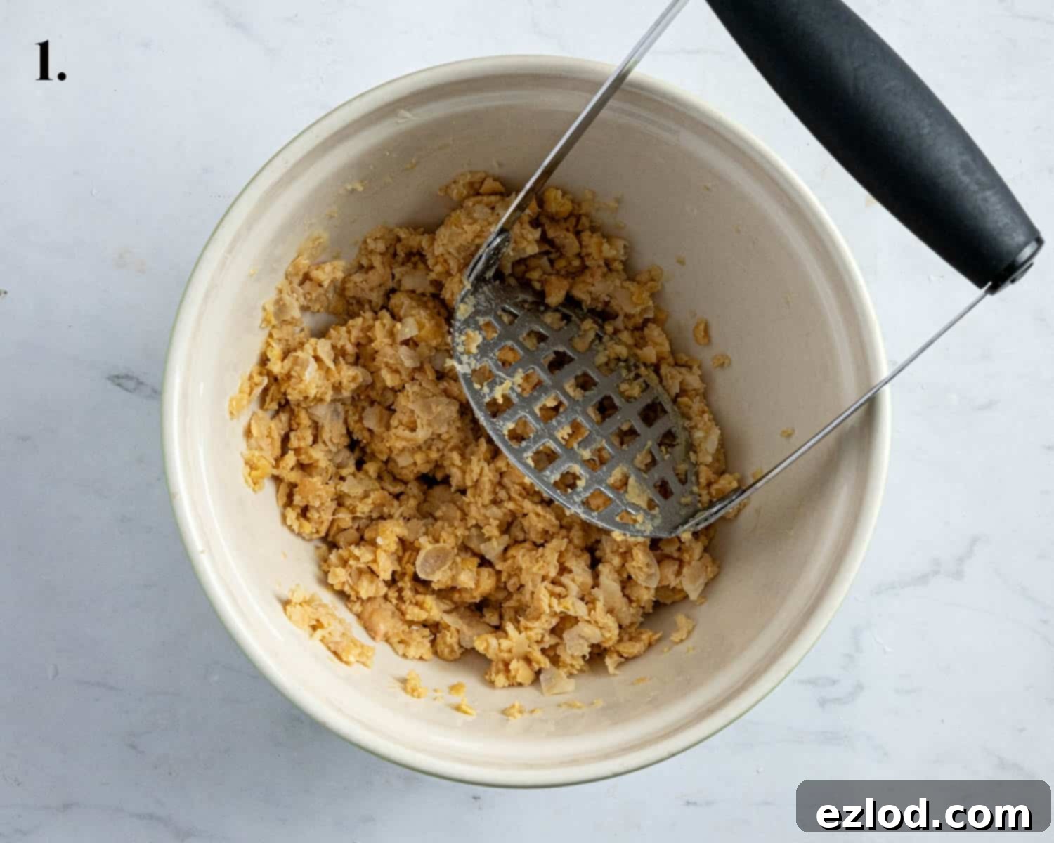 Creamy Chickpea Salad 5 Step 1 in making chickpea mayo salad: a close-up of the perfectly mashed chickpeas in a bowl, showing their retained texture.