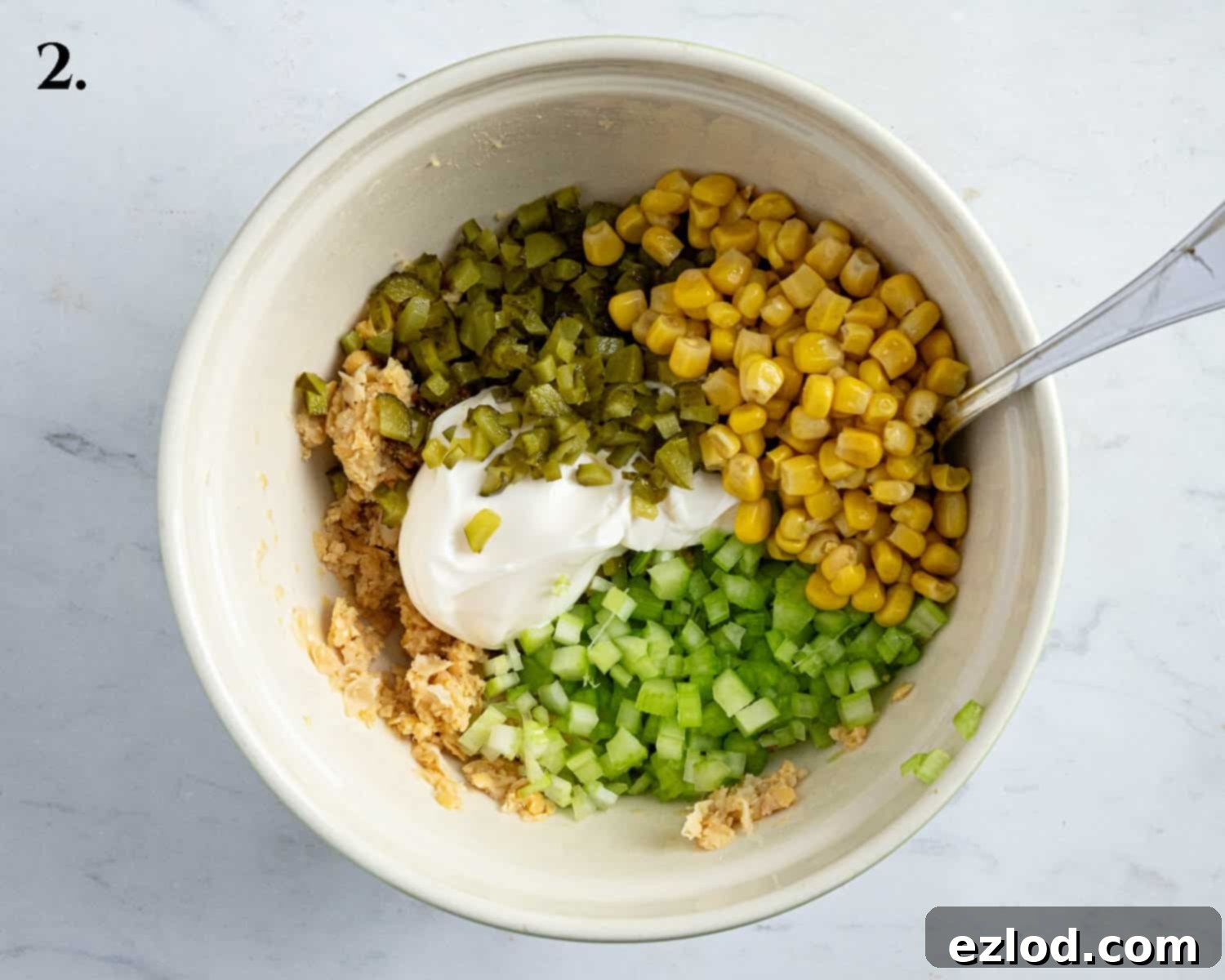 Creamy Chickpea Salad 6 Step 2 in making chickpea mayo salad: all the prepared ingredients gathered in a bowl, awaiting a thorough mix.