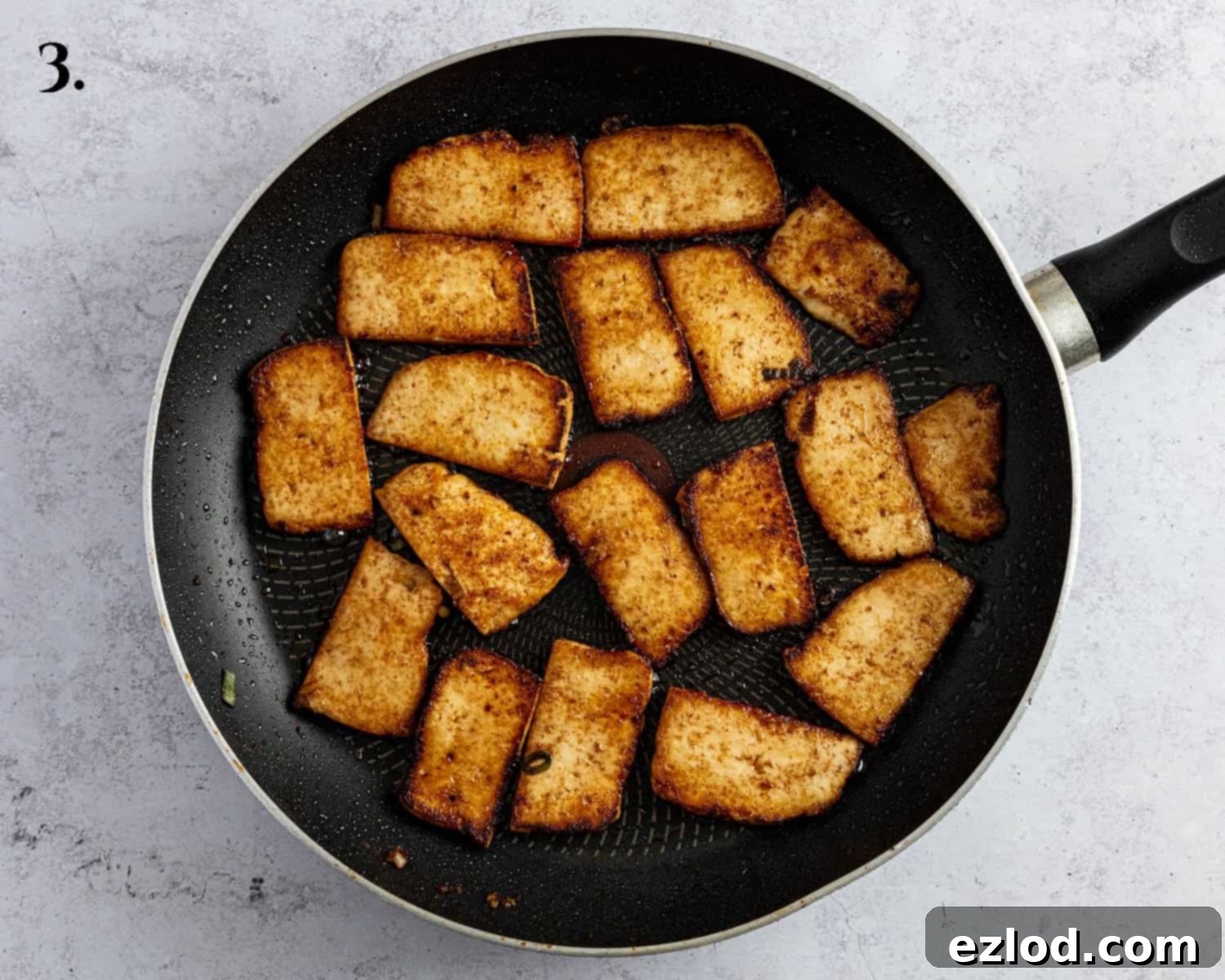 Pillowy Vegan Hoisin Tofu Bao Buns 7 Step 3, pan-fried hoisin tofu slices in a frying pan, showing their golden-brown color.