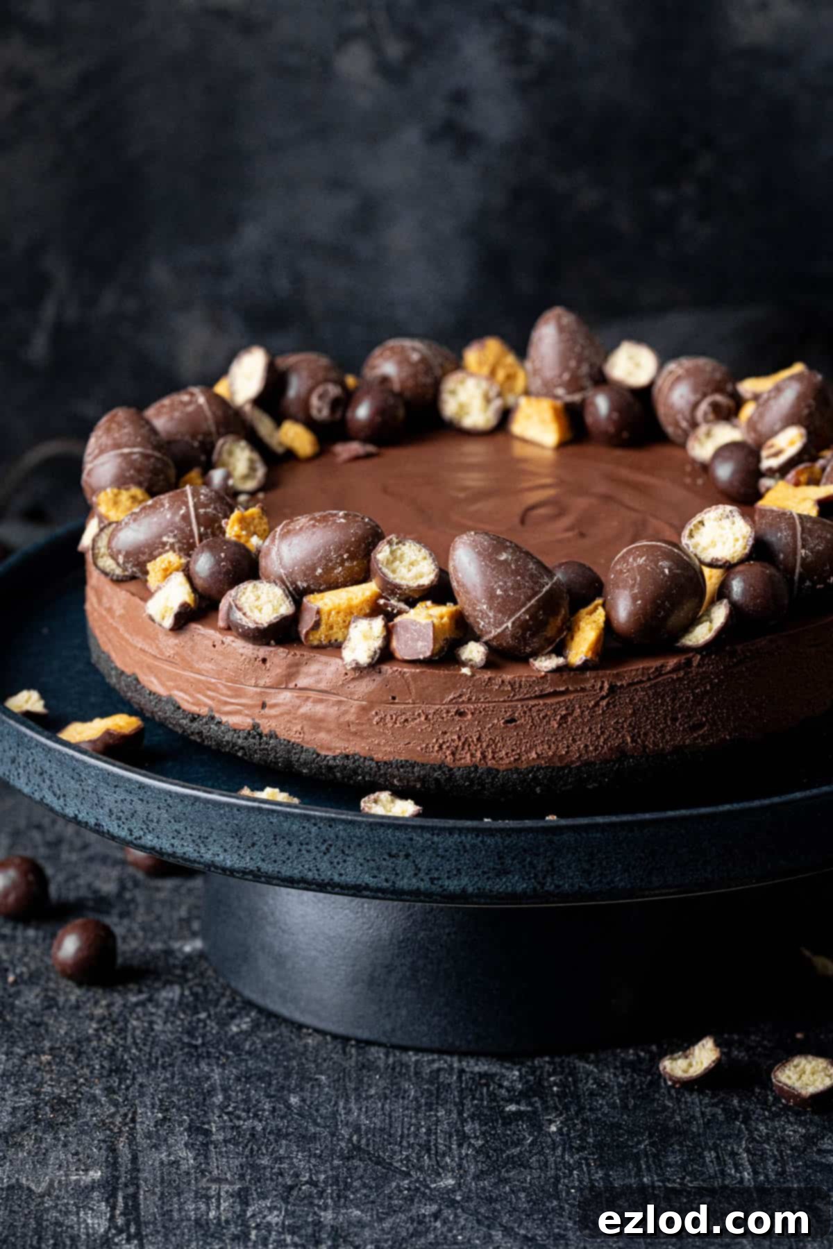 Velvet Vegan Chocolate Cheesecake 2 vegan chocolate cheesecake decorated with Easter chocolates on a black cake stand.