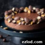 Velvet Vegan Chocolate Cheesecake 14 vegan chocolate cheesecake decorated with Easter chocolates on a black cake stand.