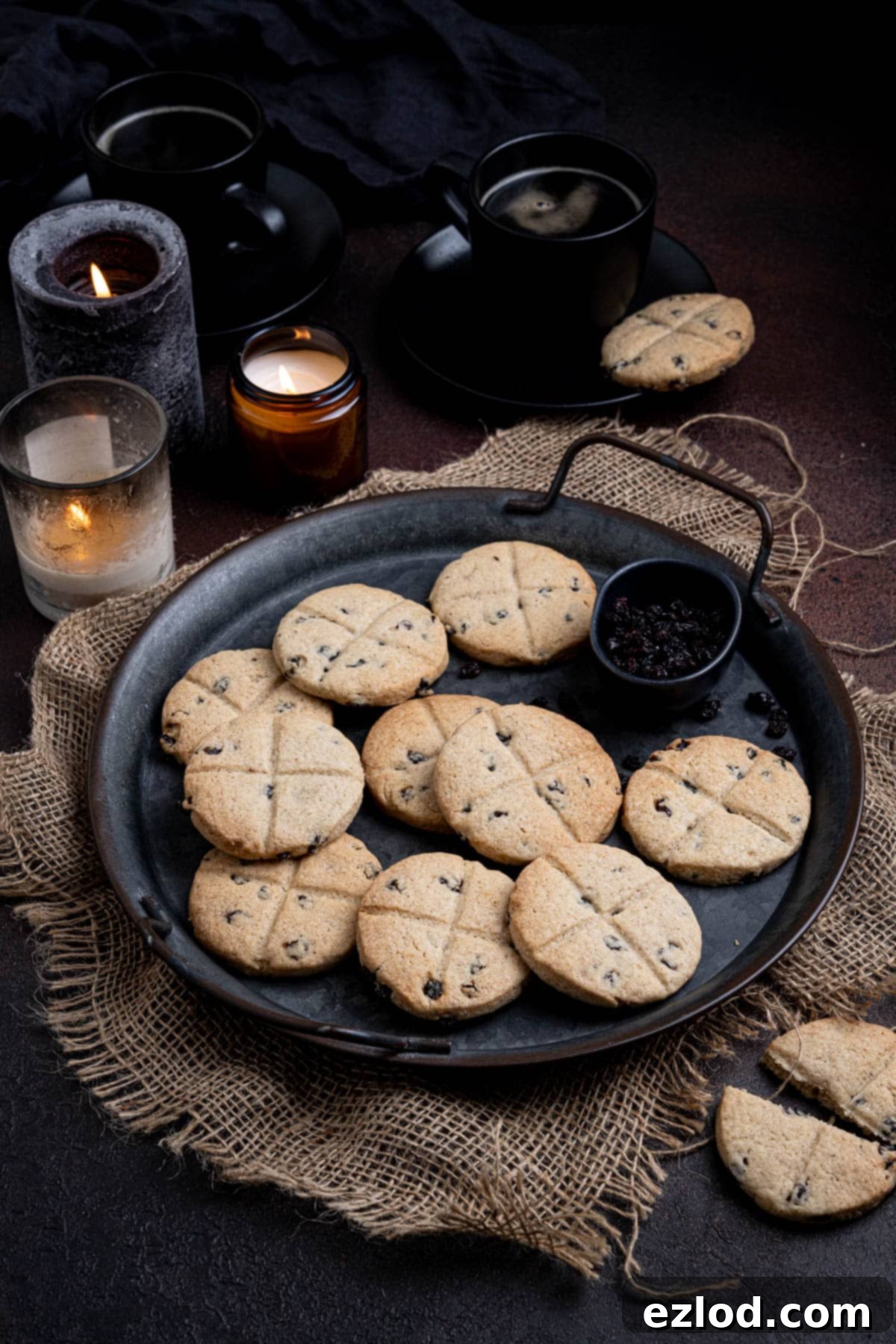 Homestyle Vegan Soul Cakes 2 Vegan soul cakes on a metal tray with candles and cups of coffee in the background.