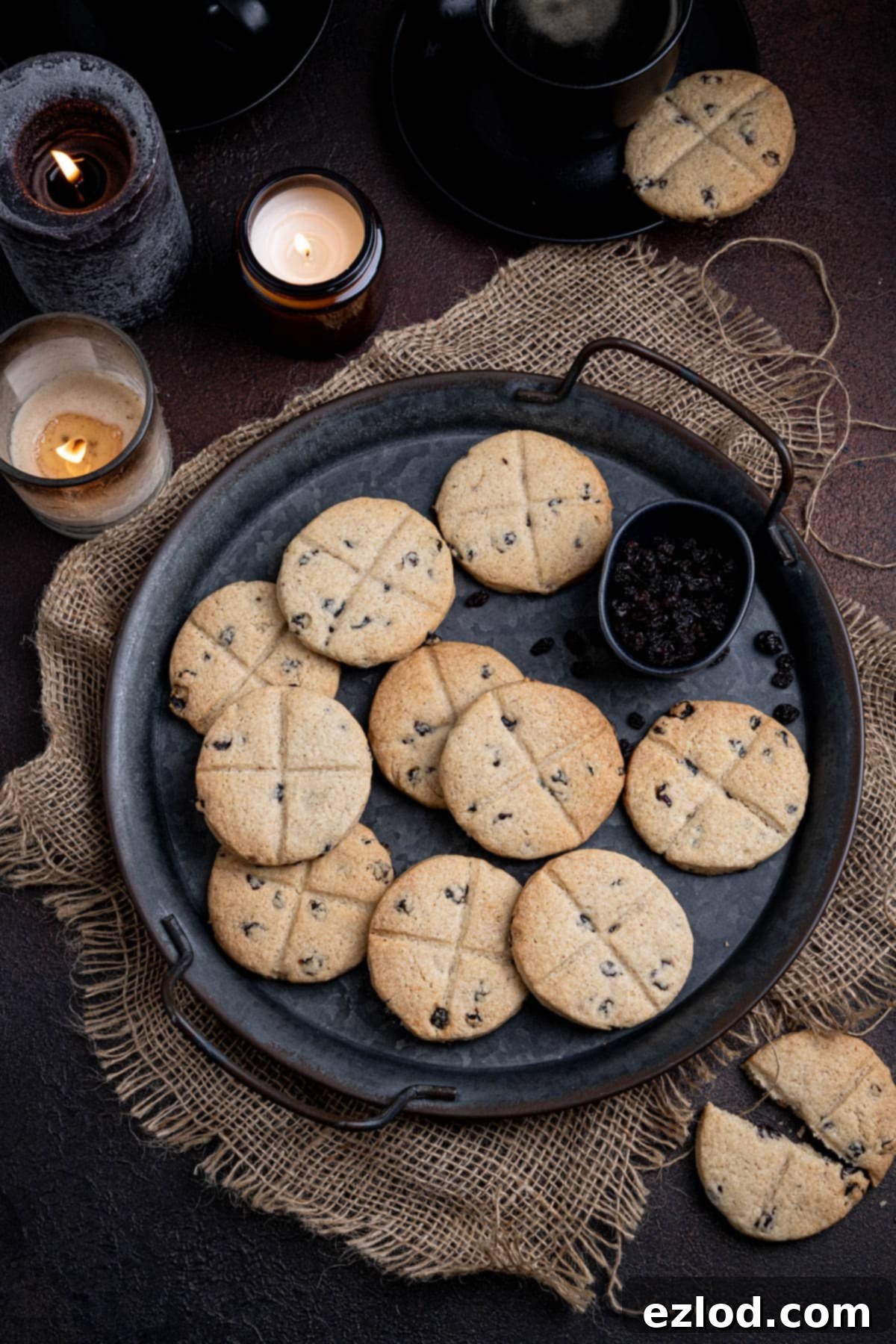 Homestyle Vegan Soul Cakes 12 Vegan soul cakes on a metal tray on a dark surface with candles and cups of coffee.