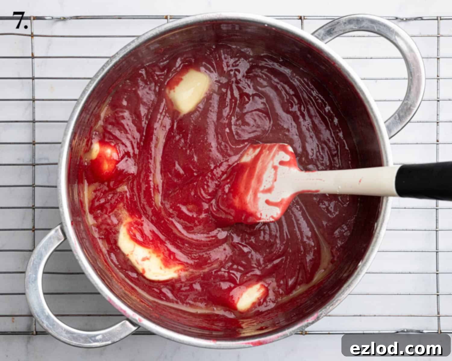 Zesty Vegan Cranberry Curd Tart 12 Step 7: Cubes of vegan butter being stirred into the hot cranberry curd, which is transforming into a smooth, glossy filling.